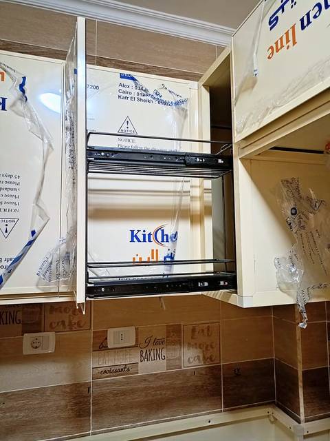 Pull-out dish rack in a wall cabinet