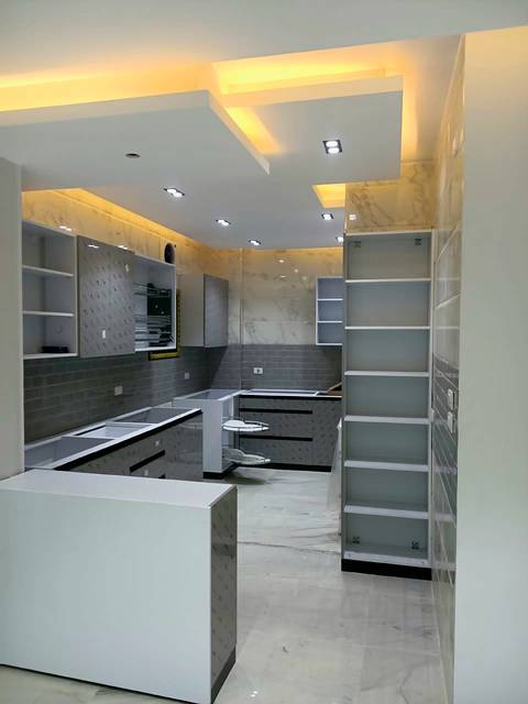 Open-plan kitchen with white open shelving