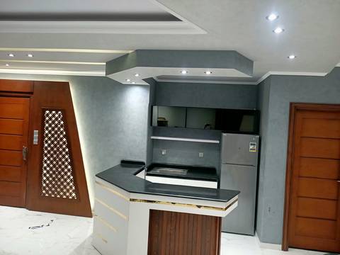Island with a black worktop and black glass cabinets