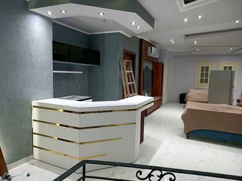 Curved white counter with gold trim