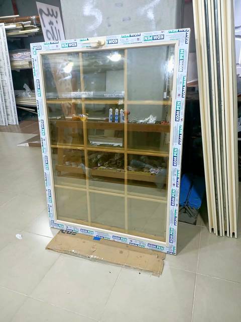 Cream uPVC window with a gold grid